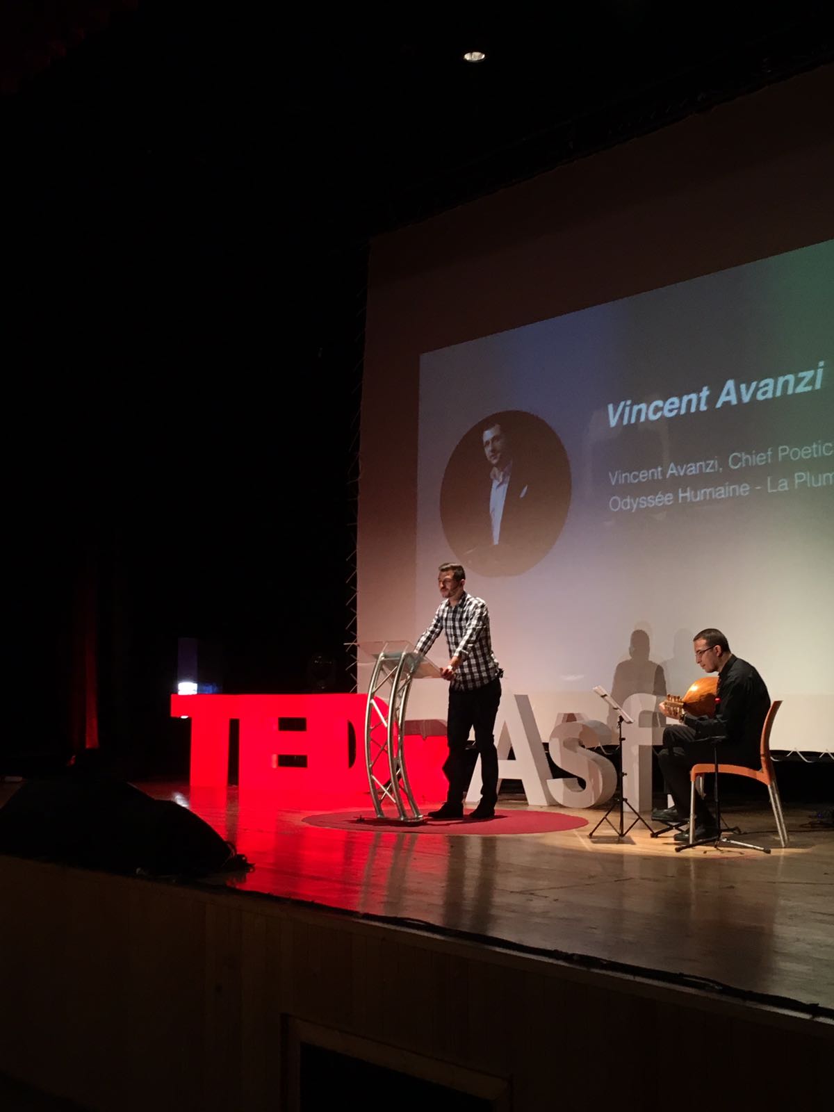 Vincent Avanzi delivers a poetic speech with a musician on the TEDx stage